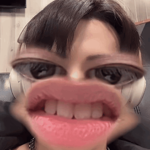 A face-distortion filter enlarges a person's eyes and mouth comically.