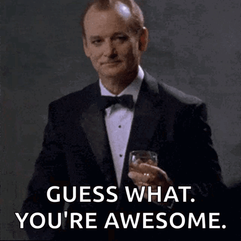 A formally dressed man holding a drink says, “Guess what. You’re awesome.”