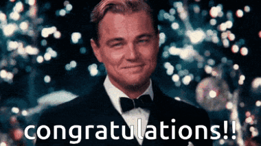 Leonardo DiCaprio in a tuxedo smiles amid falling confetti with “congratulations!!”
