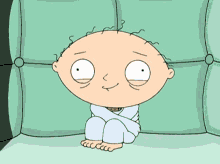 Stewie Griffin sits calmly in a green chair.