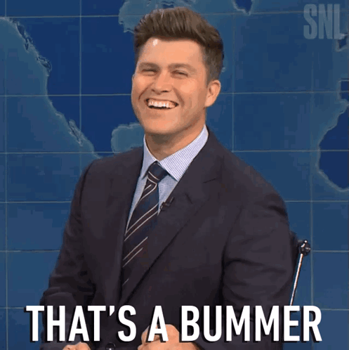 a man in a suit and tie is smiling with the words that 's a bummer behind him
