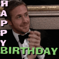 a man in a tuxedo and bow tie is clapping his hands in a happy birthday greeting .