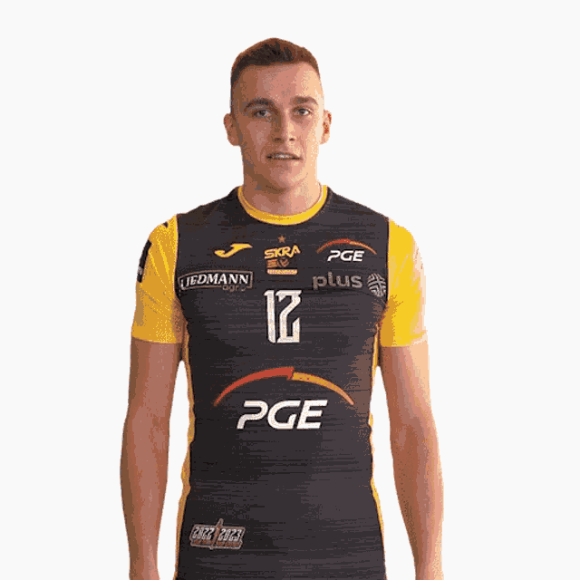 a man wearing a black and yellow pge jersey