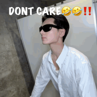a man wearing sunglasses is standing in front of a sign that says dont care