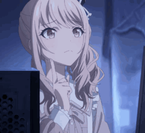 a girl with pink hair is looking at a monitor