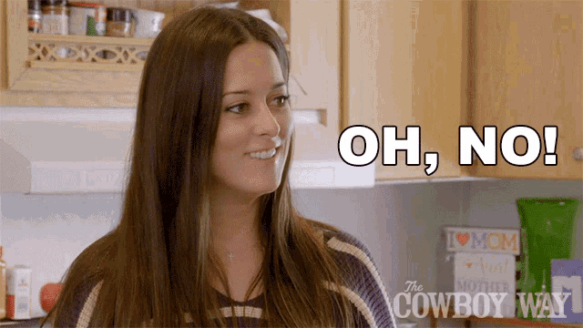 Woman looks aside as “OH, NO!” appears onscreen.