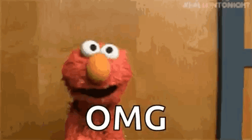 Elmo looks stunned beside a large “OMG” caption.