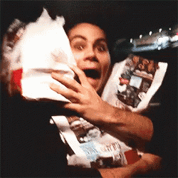 a person is holding a bag of food in their hands