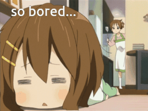 Yui from K-On! lies face-down on a table looking exhausted and bored.