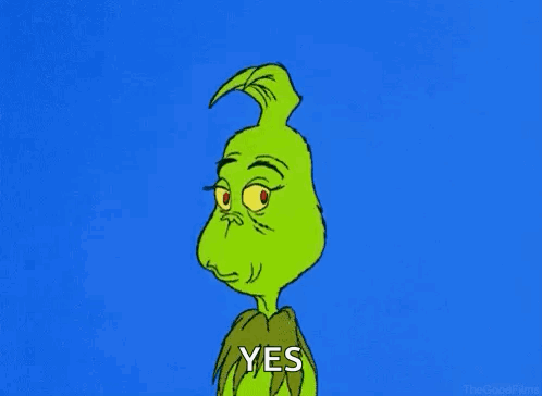 The Grinch gives a sly smile beside a small “YES.”