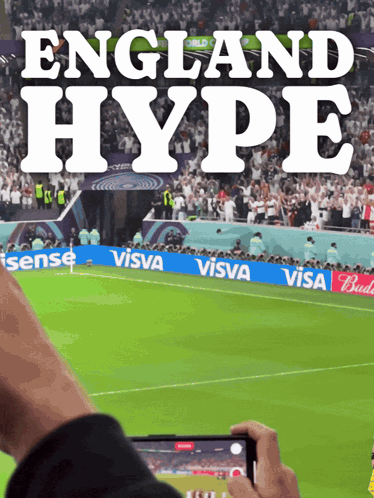 a person taking a picture of a soccer field with the words " england hype " on it