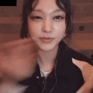a close up of a woman 's face with headphones on .