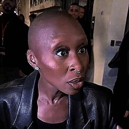 Cynthia Erivo gives a dramatic wide-eyed reaction at an event.