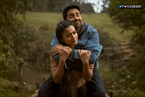 a man is carrying a woman on his back with the twitter username 7wickreddy visible in the corner