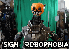 a robot with a pumpkin on its head and the words sigh robophobia on the bottom