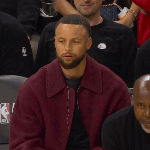 a man with a beard wearing a purple jacket