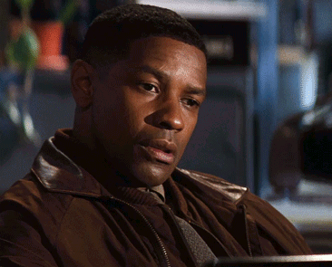 A man gazes down with a relieved, reflective expression.
