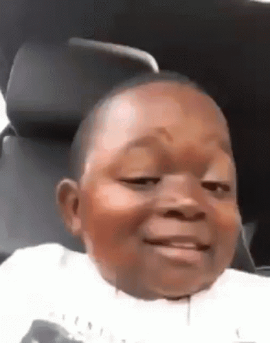 A child smiles and gives a wink in a low-resolution clip.