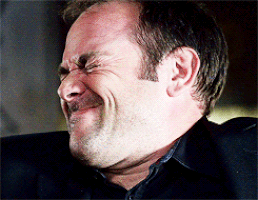 a man with a mustache is making a funny face