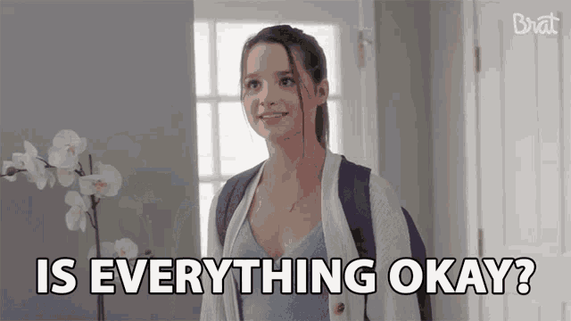 a girl with a backpack is standing in front of a door and asking is everything okay .