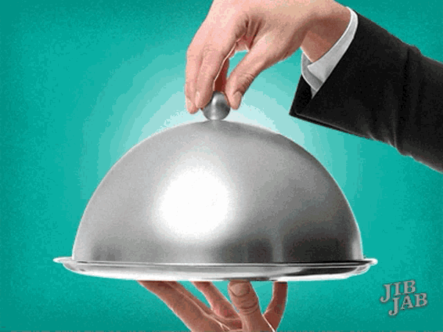 a person is holding a silver tray with a lid and the words jib jab on it