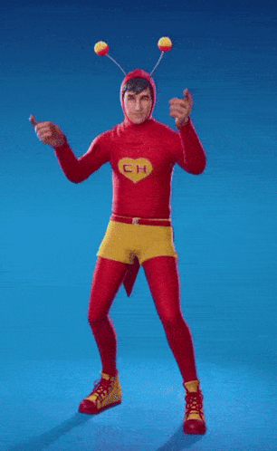 a man in a red and yellow costume with the letter ch on his chest