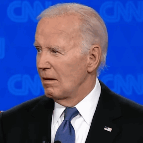 Joe Biden turns with a bewildered expression at a debate.