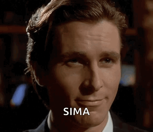 Patrick Bateman smirks while looking sideways.