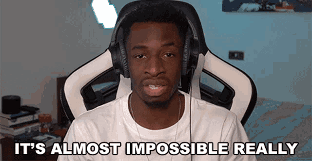 a man wearing headphones says it 's almost impossible really while sitting in a chair