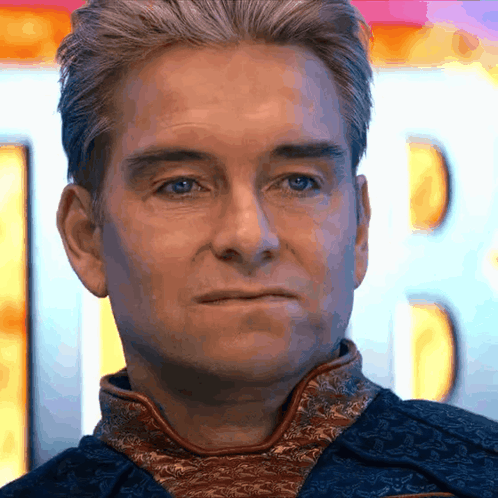 Homelander looks forward with a restrained, displeased expression.