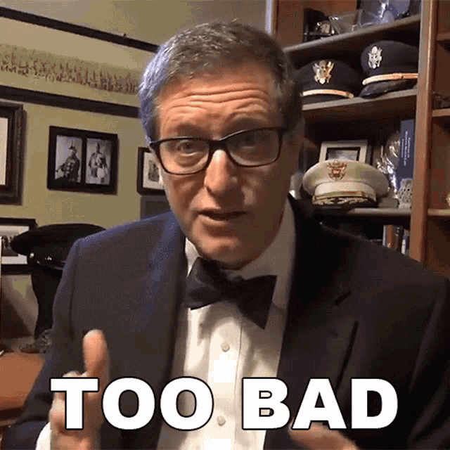 a man wearing a suit and bow tie says too bad