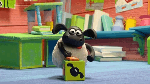a cartoon sheep is playing with a green block with a sheep face on it