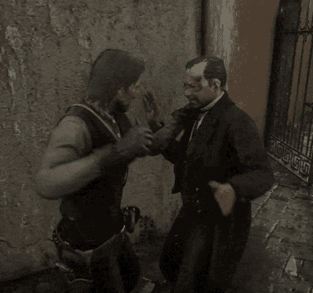 a man in a suit is being punched in the face by another man in a black jacket