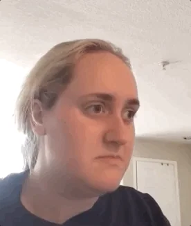 Brittany Broski shifts from a doubtful look to a considering expression in a selfie video.