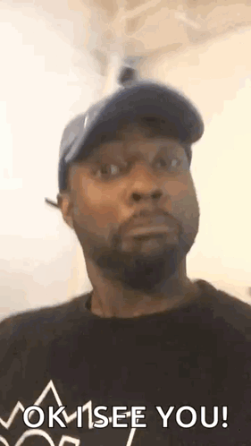 A man in a cap stares with an impressed, surprised expression.