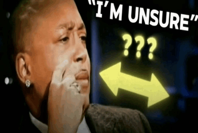 a man in a suit is making a funny face with the words " i 'm unsure " above him