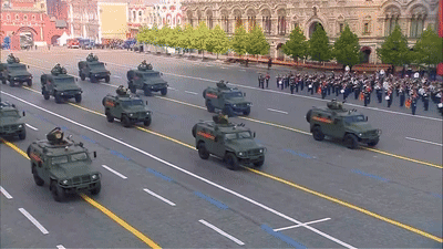 a group of military vehicles are driving down a road