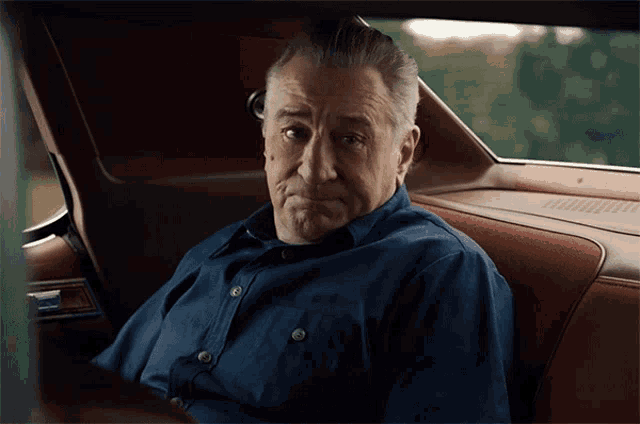 a man is sitting in the back seat of a car