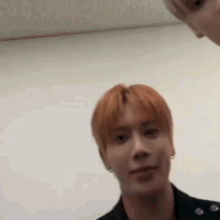 a man with red hair is making a funny face while looking at the camera .