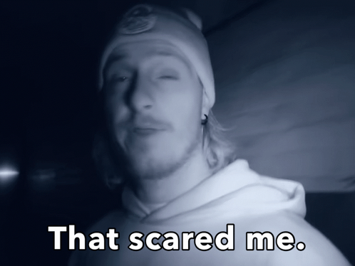 a man wearing a beanie and a white hoodie says that scared me