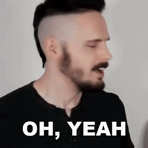 a man with a beard and mohawk is making a funny face and saying `` oh , yeah '' .