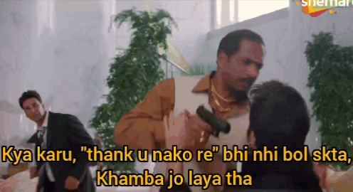 a man holding a gun says " thank u nako re " while another man watches
