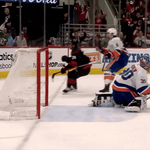 a hockey game is being played in front of a banner for hop.com