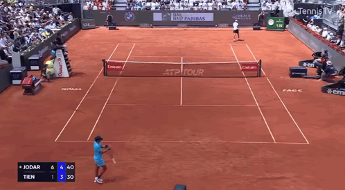 a tennis player is swinging a racket in front of an ea7 sign