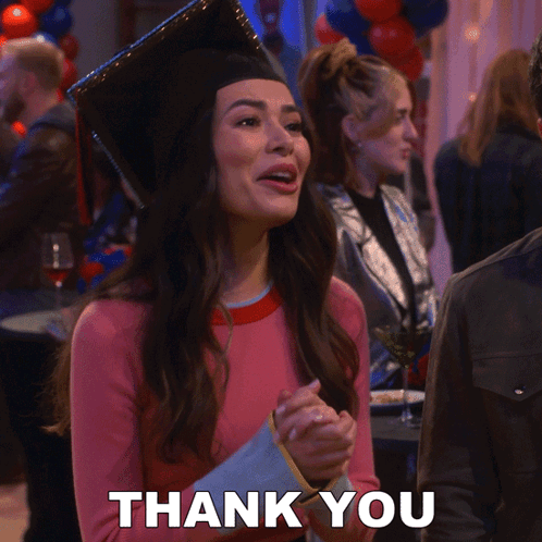 a woman wearing a graduation cap and gown says " thank you "