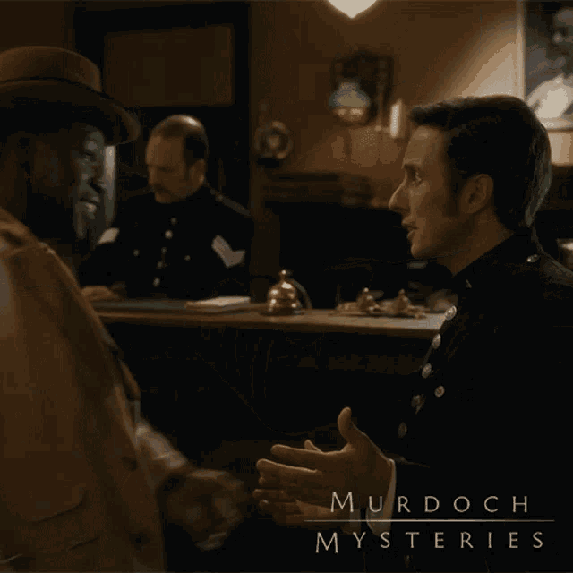 a murdoch mysteries poster shows two men hugging