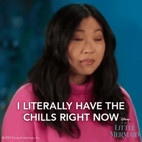 a woman is wearing a pink sweater and says i literally have the chills right now .