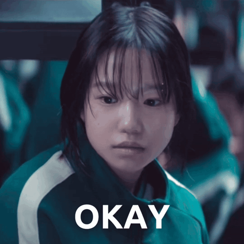 a girl in a green jacket says okay