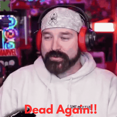 a man with a beard wearing headphones and a bandana says dead again