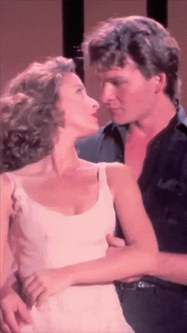 a man and a woman are dancing together and looking at each other